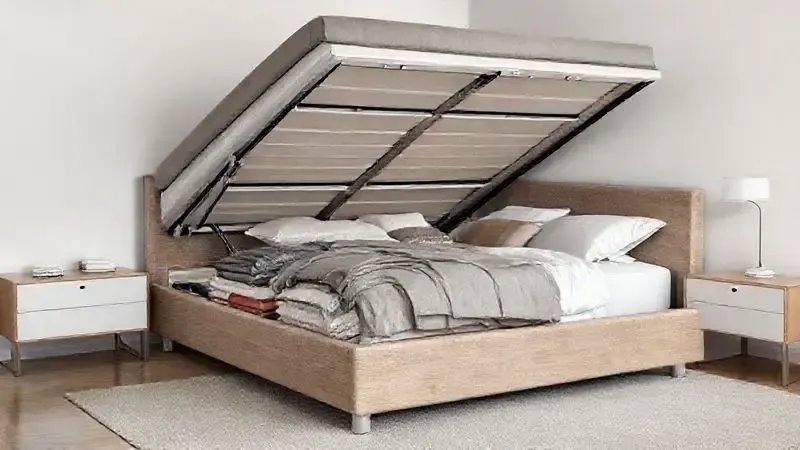 Render 3D de uma cama box baú queen aberta, mostrando o amplo e organizado espaço de armazenamento interno para roupas de cama e objetos.